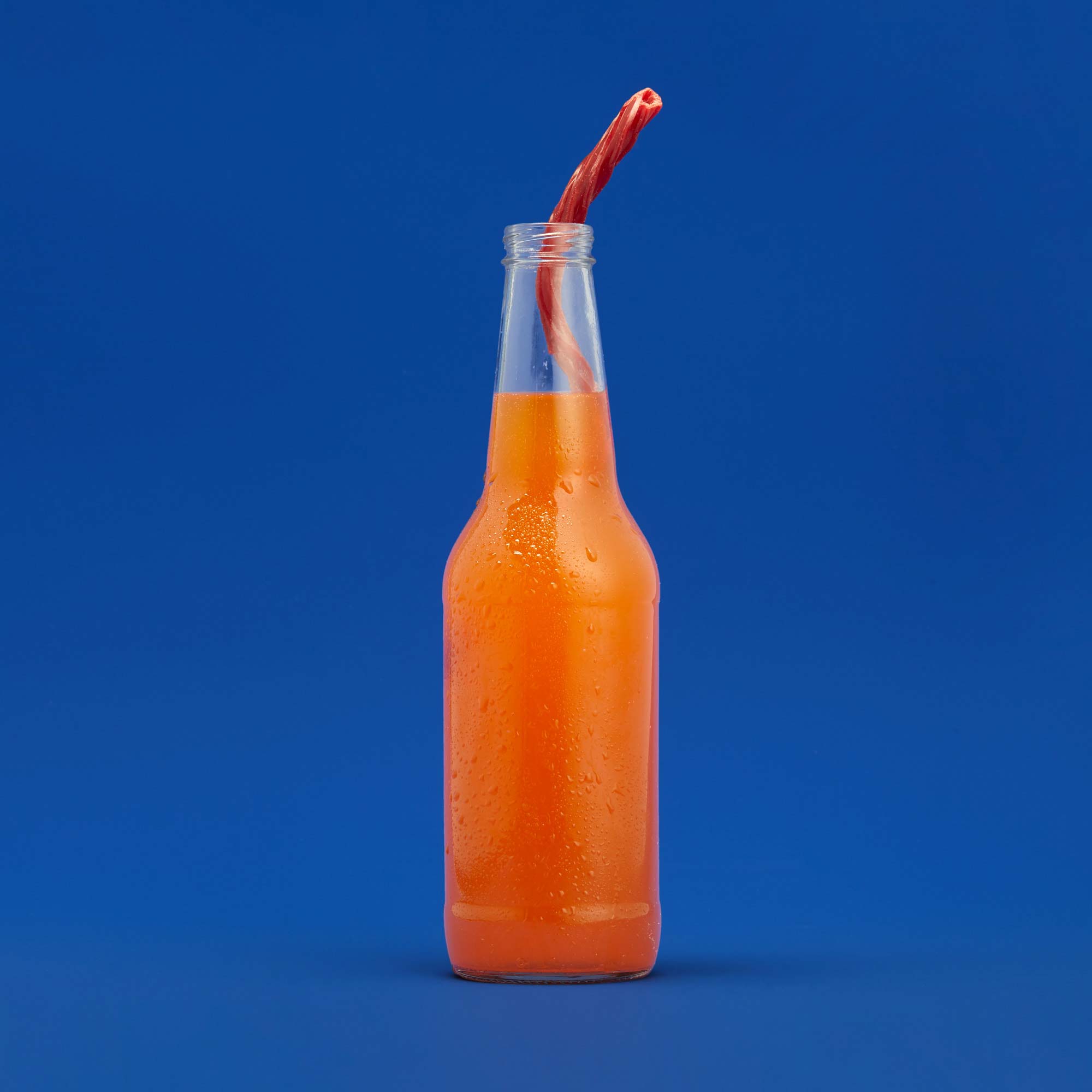Twizzler Straw in a bottle of orange soda