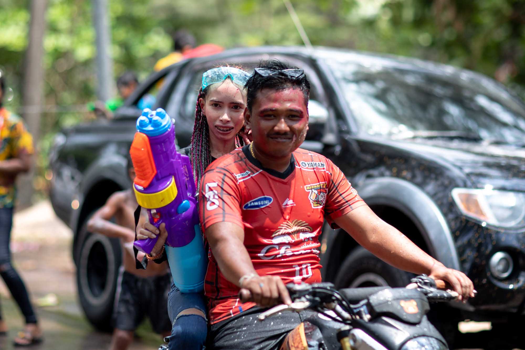 Man and woman on a motorcycle curing Songkran water festival in Phuket, Thailand | Street Photography | Travel Photography | Festival Photography