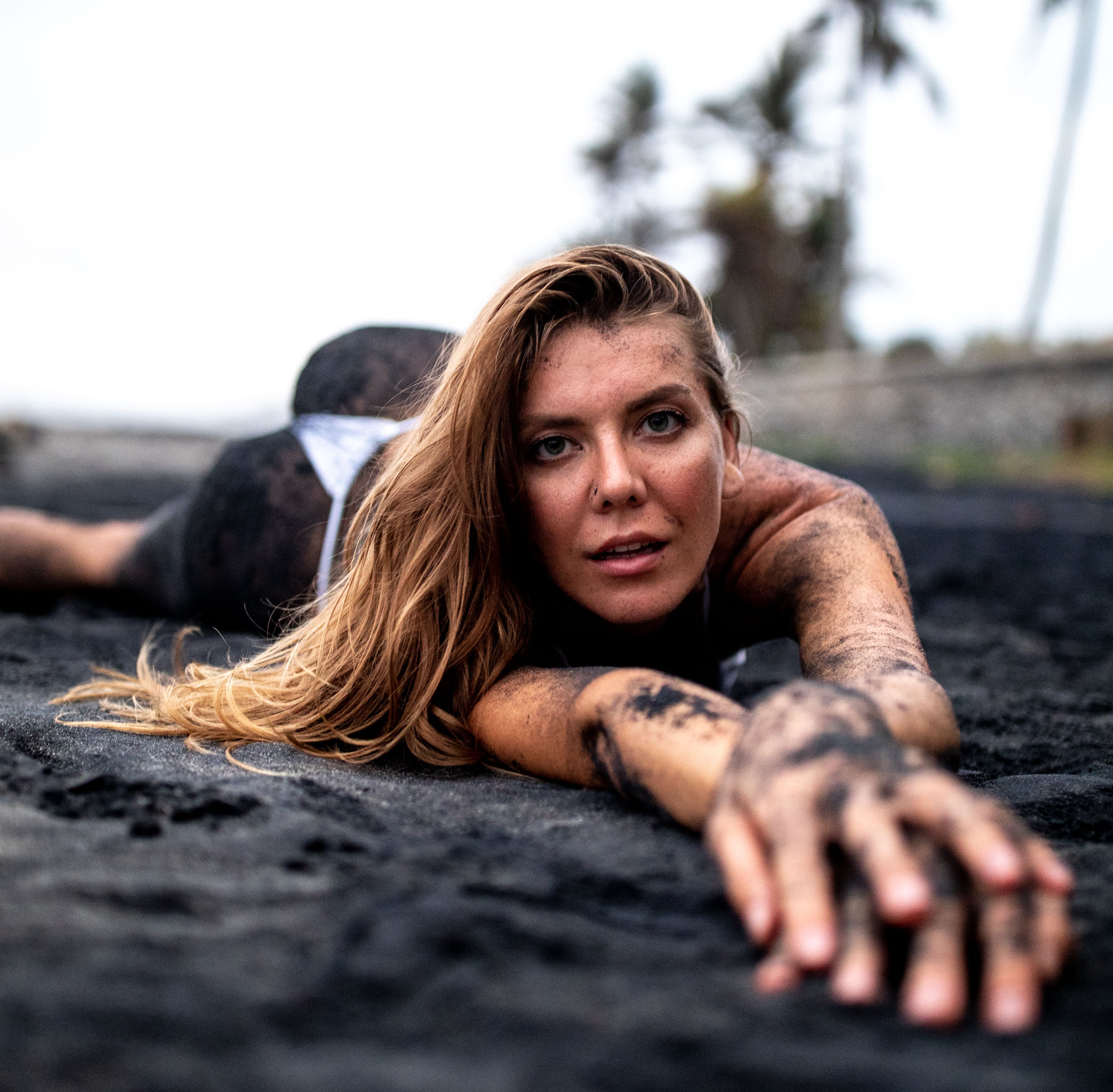 Bikini model rolling around and getting dirty on a black sand beach | Swimwear | Lifestyle Photography | Canggu, Bali, Indonesia