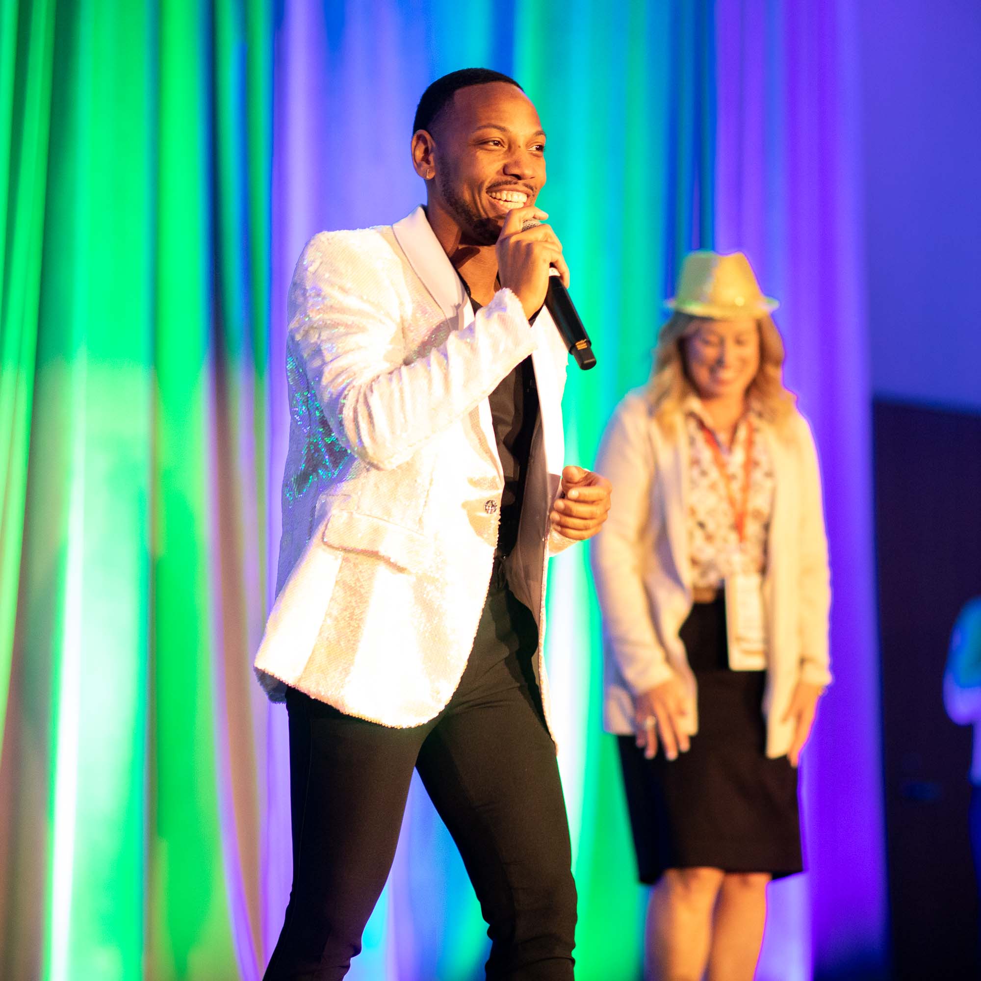 Singer on stage at corporate event smiling
