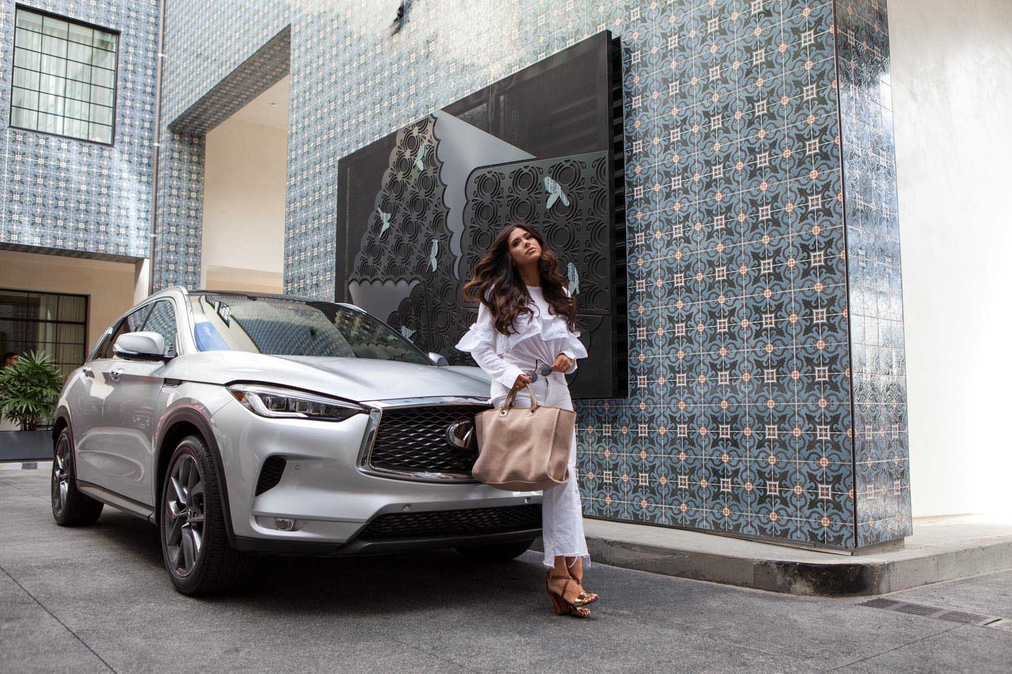 Fashion Photography, driving and posing in front of new Infiniti QX50